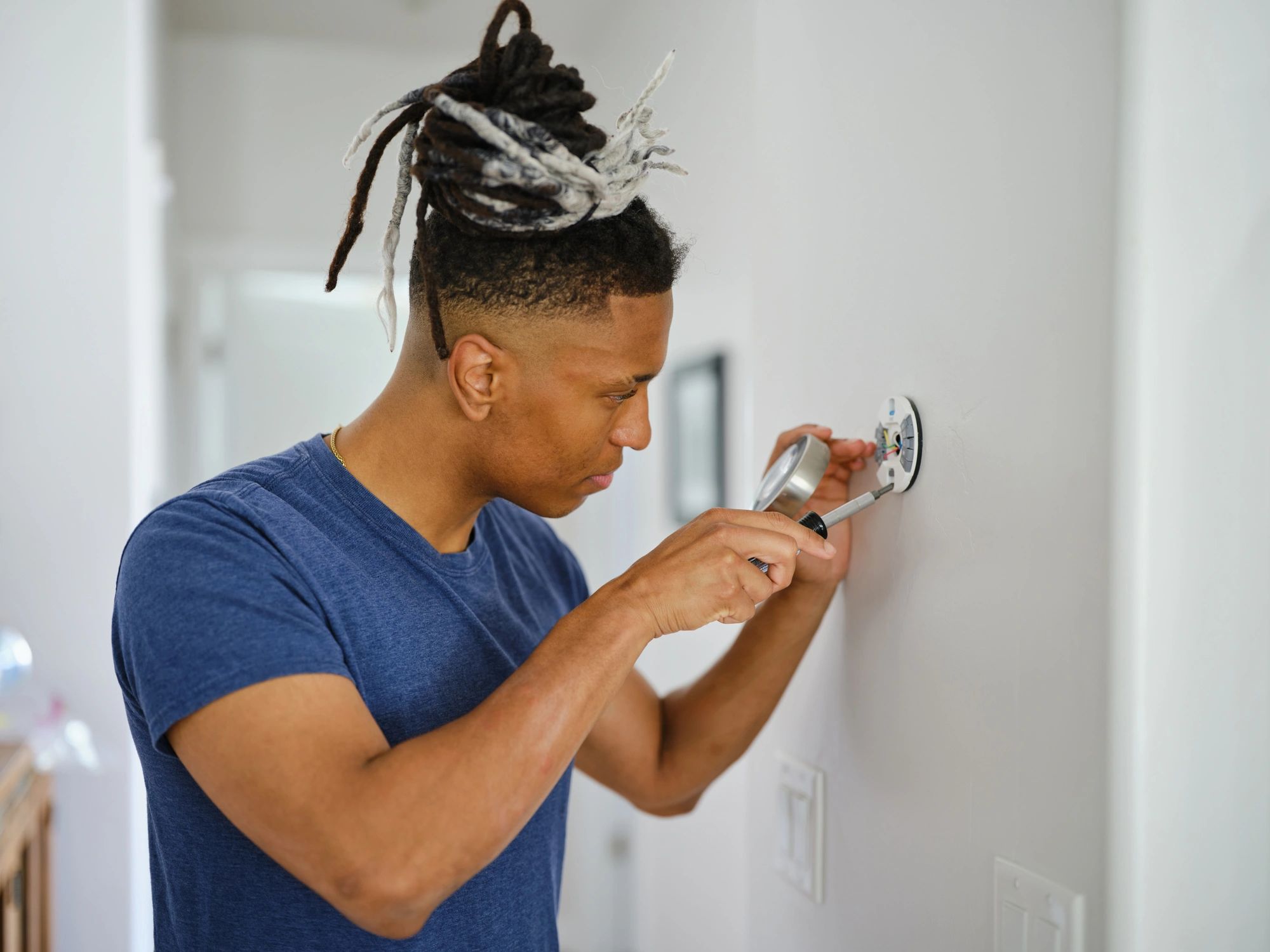 Technician installing a smart home thermostat