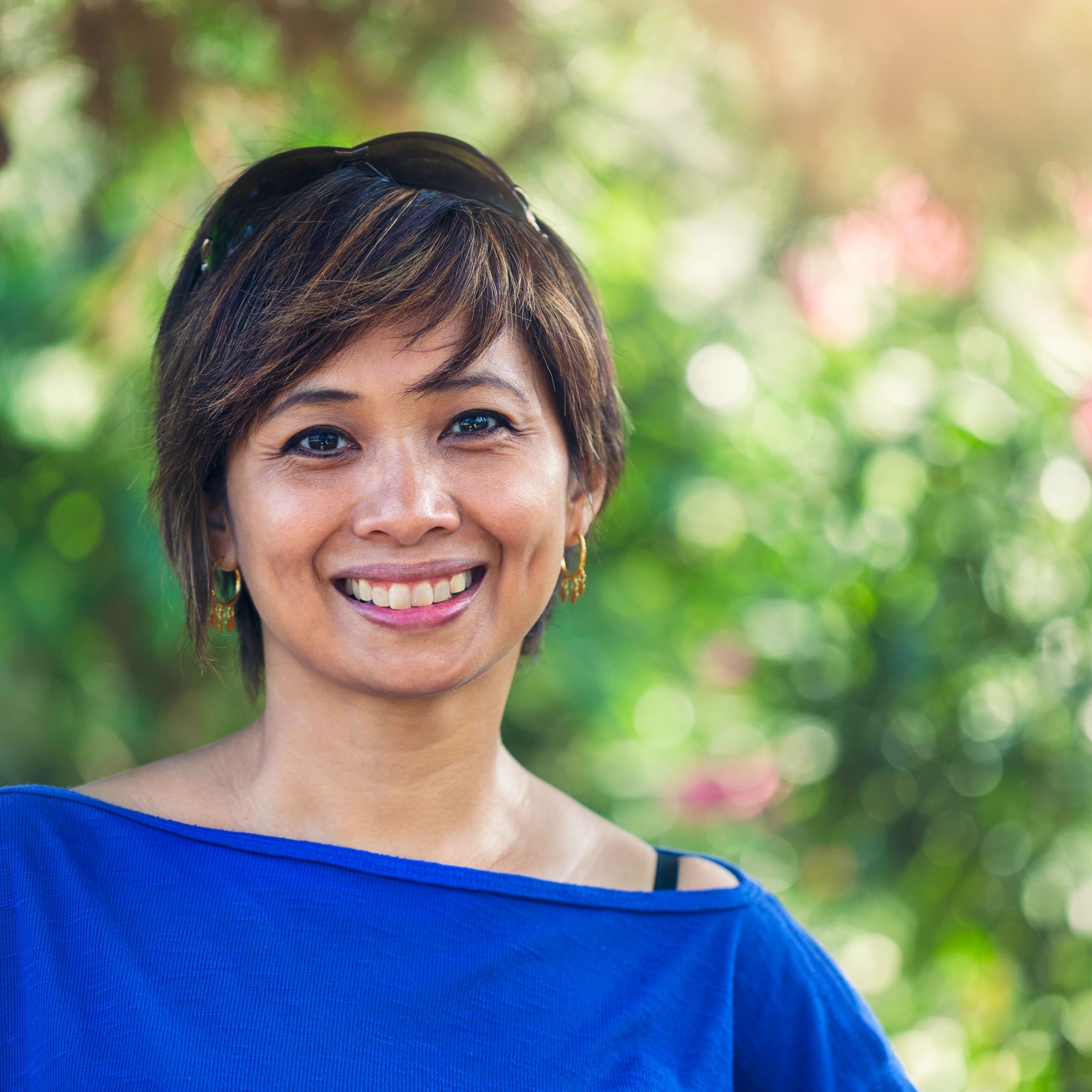 Smiling homeowner outdoors in a garden